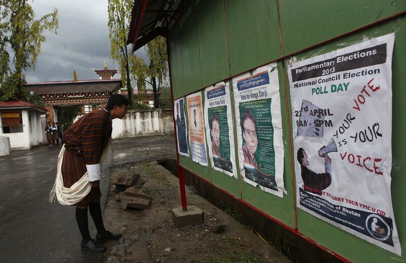 A Bhutanese man looks at posters of candidates on the eve of polling to the upper house National Council in Samdrup Jonkhar, Bhutan, April 22, 2013. Bhutan ended more than a century of absolute monarchy with its first parliamentary elections in 2008. (Anupam Nath/AP)