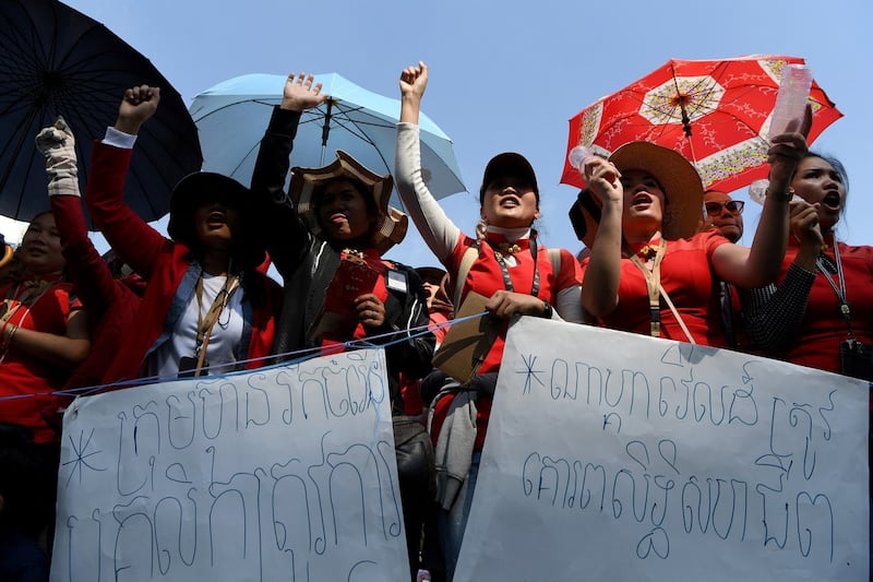 People shout slogans in front of NagaWorld hotel and casino during a protest in Phnom Penh, Jan. 10, 2020. AFP