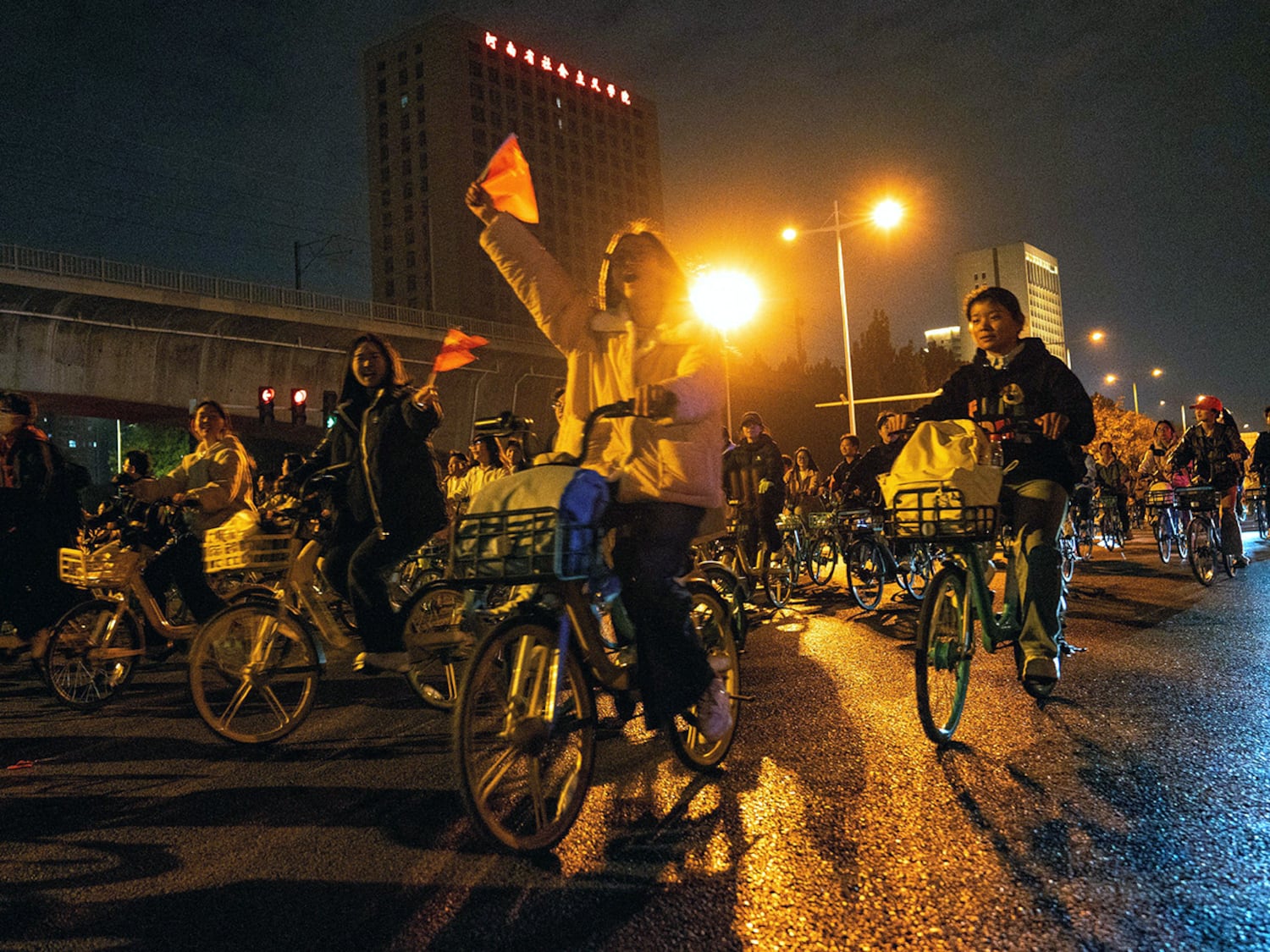 College students  ride on on the Zhengkai Road in Zhengzhou, China, to eat dumplings in a nearby city, Nov. 9, 2024.