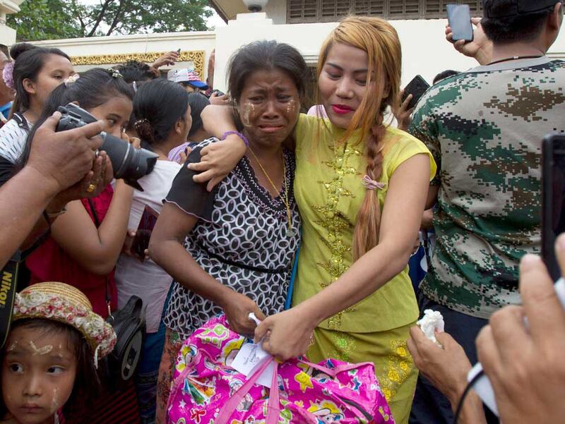 A female prisoner, right, is welcomed by her mother after being released from Insein Prison. (AP)