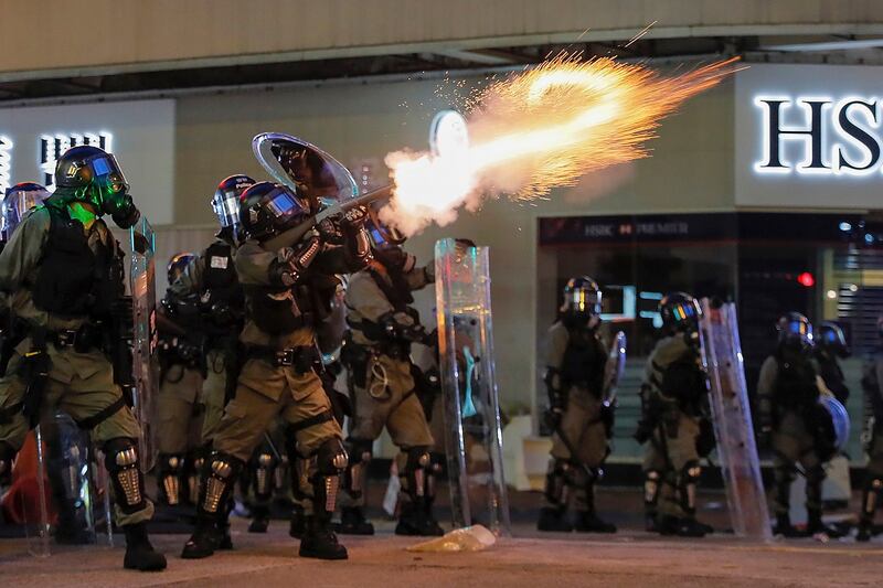 Riot police fire tear gas during the anti-extradition bill protest in Hong Kong, Aug. 11, 2019. Credit: AP Photo