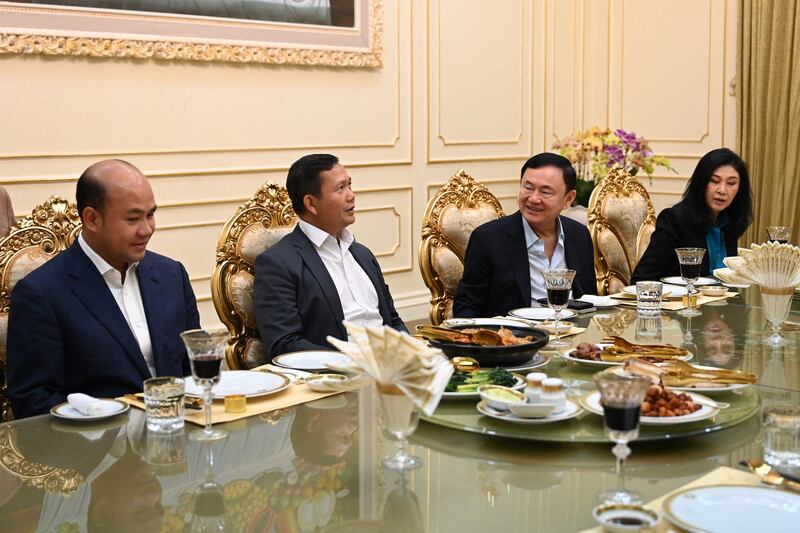 Hun Many, left, looks on as his brother, Hun Manet, talks with Thailand's former Prime Minister Thaksin Shinawatra during an event for Hun Sen's birthday in Phnom Penh, Aug. 5, 2023. Thaksin's sister and former Thai Prime Minister Yingluck Shinawatra is at far right. (AFP)