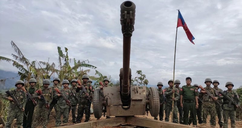 Arakan Army soldiers stand with an artillery piece after capturing the Myanmar junta's Ta Ron Aing base in Chin state, Dec. 4, 2023. (AA Info Desk)