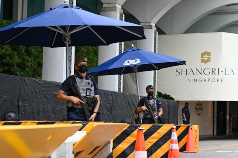 Police stand guard outside the venue of the 19th Shangri-La Dialogue in Singapore on June 10, 2022. AFP