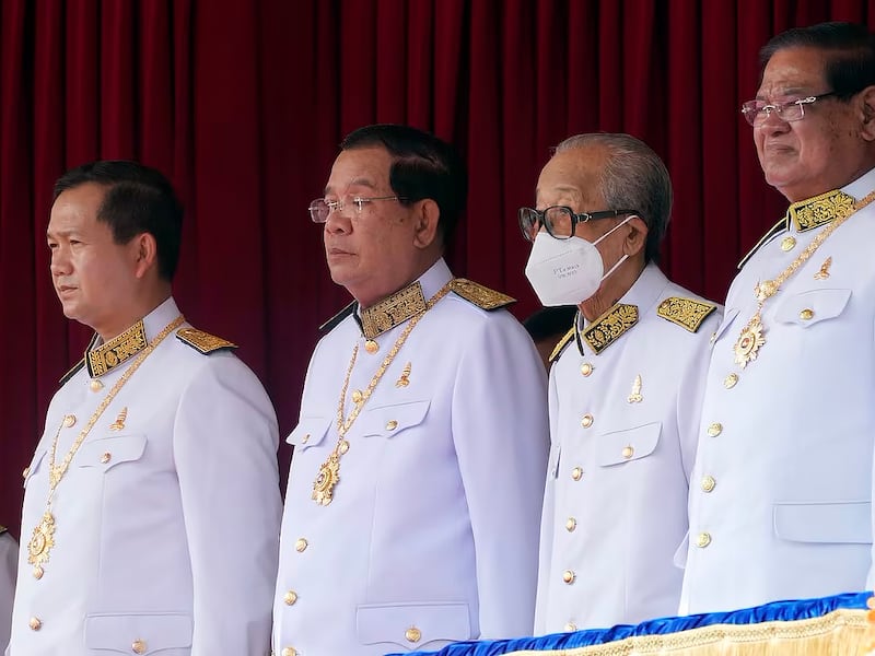 Cambodian Prime Minister Hun Manet, far left, stands next to his father Hun Sen,  former prime minister, left,  during the country's 70th Independence Day in Phnom Penh, Nov. 9, 2023.