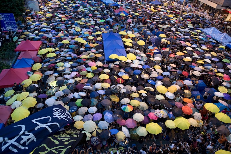 Pro-democracy protesters open their umbrellas to mark one month since they took the street, in the Admiralty district of Hong Kong, Oct. 28, 2014. (Nicolas Asfouri/AFP)