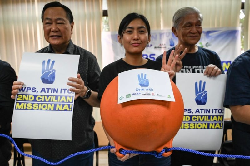 Members of the Atin Ito! (This Is Ours!) show the buoys that will be used in Scarborough Shoal, during a press conference in Quezon City, Metro Manila, May 8, 2024. (Jam Sta Rosa/AFP)