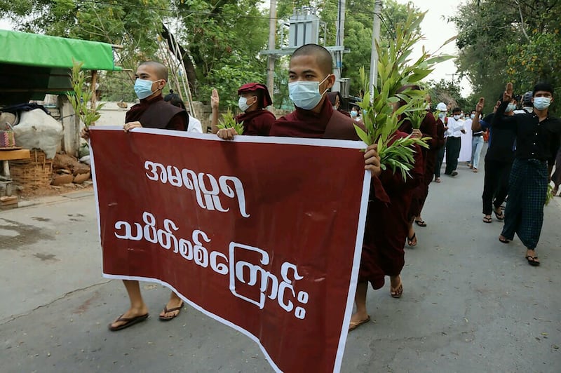 This photo taken and received from an anonymous source on April 24, 2021 shows Buddhist monks marching during a demonstration against the military coup in Mandalay. AFP