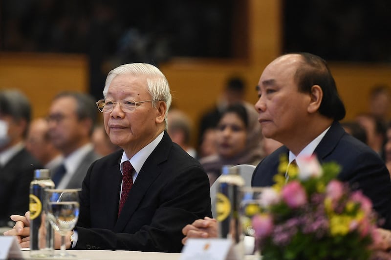 Vietnam's Communist Party General Secretary Nguyen Phu Trong, left, and Vietnam's then-Prime Minister Nguyen Xuan Phuc attend the ASEAN summit via video, in Hanoi on Nov. 12, 2020. (Nhac Nguyen/AFP)