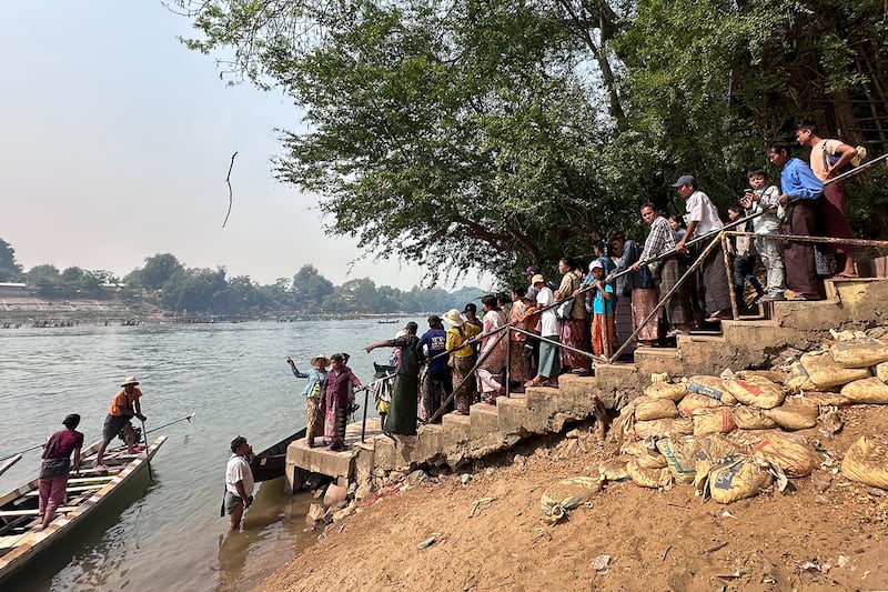 Visitors wait to hop on a boat at the annual Shwe Saryan Pagoda harvest festival in Shwe Saryan village, Patheingyi township, Mandalay region, Myanmar, March 11, 2025.