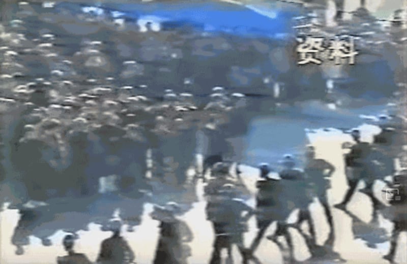 Uyghur protesters face Chinese security forces on a street in Ghulja in northwestern China's Xinjiang region, February 1997, in a screenshot from a video of a Chinese television report smuggled out of China. UK's Channel 4 News report/YouTube