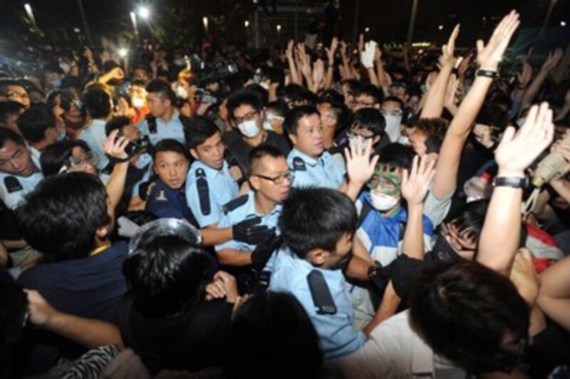 Police yell at pro-democracy protesters near the government headquarters in Hong Kong, Oct. 16, 2014.