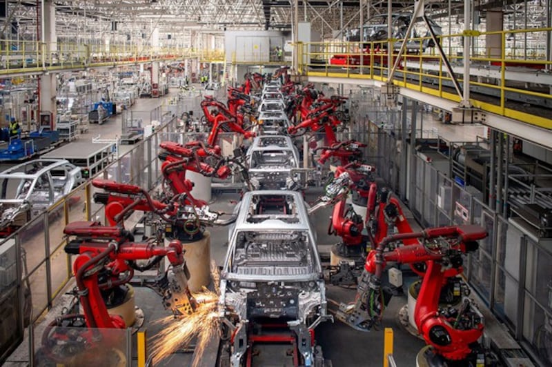 Robotic arms assemble electric vehicles at a Leapmotor factory in Jinhua in eastern China's Zhejiang province, April 26, 2023. (Reuters)