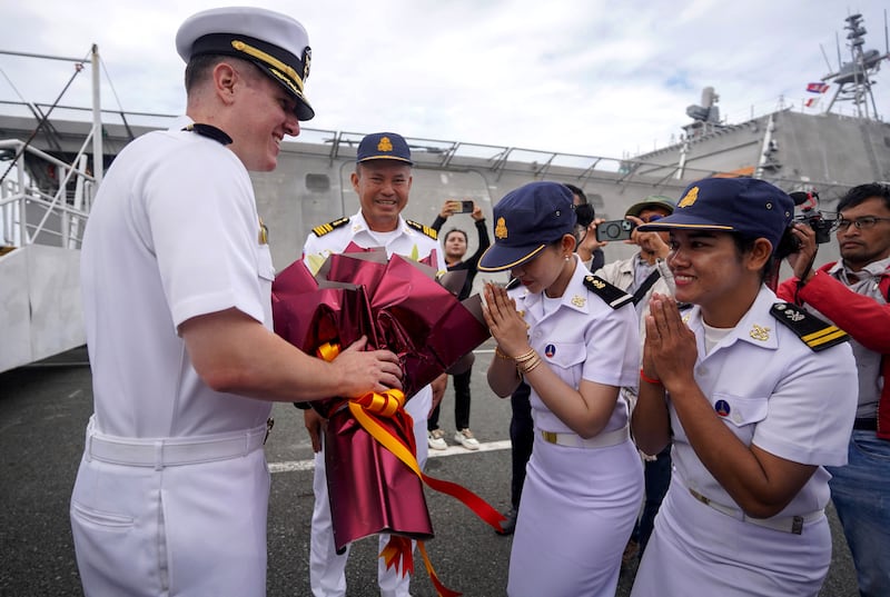 Commander Daniel Sledz of the USS Savannah receives flowers from members of the Royal Cambodian Navy after docking in Cambodia's southern port city of Sihanoukville, Dec. 16, 2024.