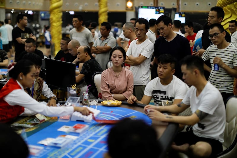 Chinese guests sit around a gambling table during the opening night of DV Casino in Sihanoukville, Cambodia, May 18, 2019. Sihanoukville was originally intended as a seaside resort, but is now basically a city of Chinese casinos under the strong influence of Chinese tycoons, sources said. Credit: Reuters