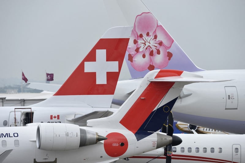 The logos of Swissair (L) and China Airlines (R) are seen on the fins of long-haul airplanes on the opening day of the International Paris Airshow, June 15, 2015.