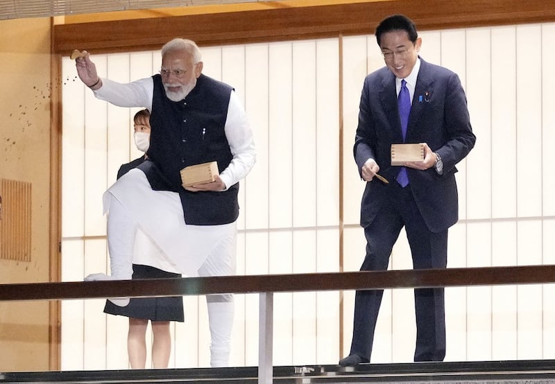 Indian Prime Minister Narendra Modi (L) and Japanese Prime Minister Fumio Kishida feed carp before their dinner at Akasaka State Guest House in Tokyo on May 24, 2022, following the end of the Quad leaders' summit between the US, Japan, India and Australia. Credit: AFP