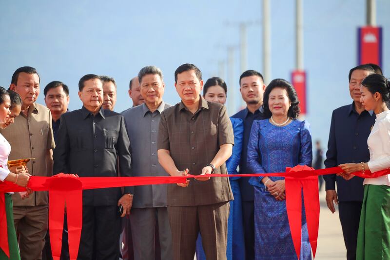 Cambodian Prime Minister Hun Manet (C, front) cuts the ribbon at the launching event of the Kampot Multipurpose Port in Kampot province, Cambodia, June 6, 2024. (Ly Lay/Xinhua via Getty Images)