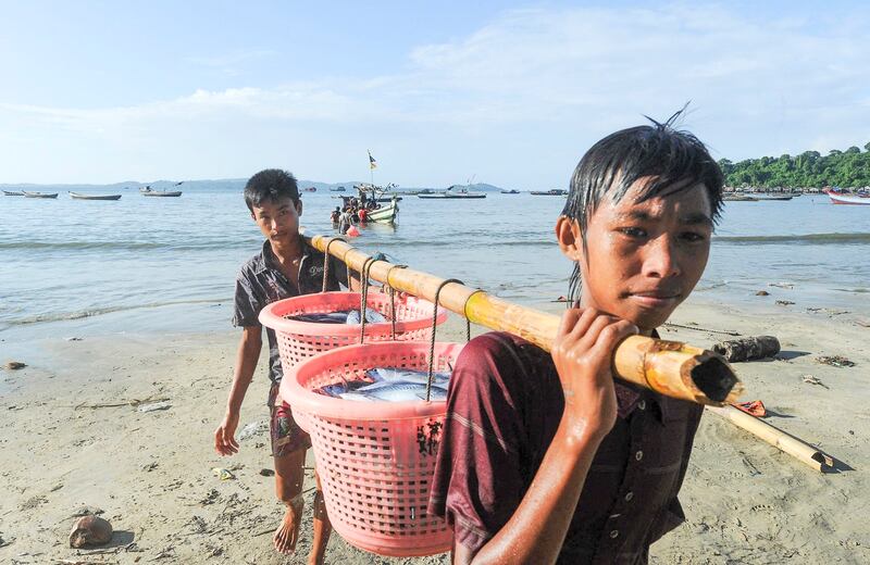 Fishermen haul fish ashore from their boat October 4, 2013, at the beach in Ngapali, near Thandwe, in Myanmar's western Rakhine state. (Soe Than Win/AFP)