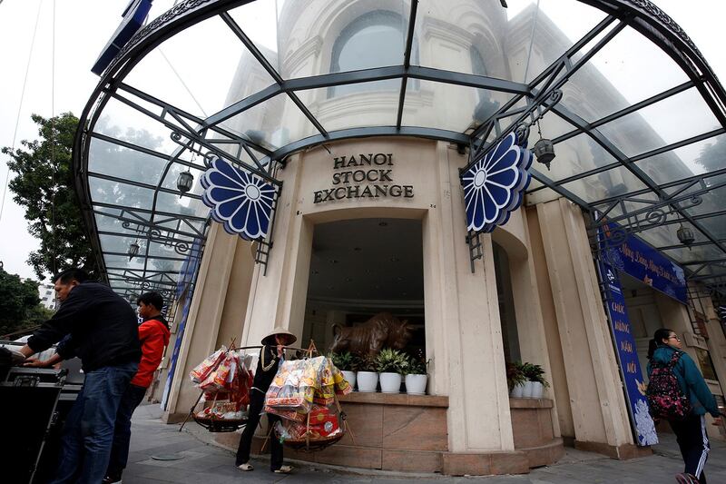 People walk past the stock exchange in Hanoi, Jan. 26, 2018. (Kham/Reuters)