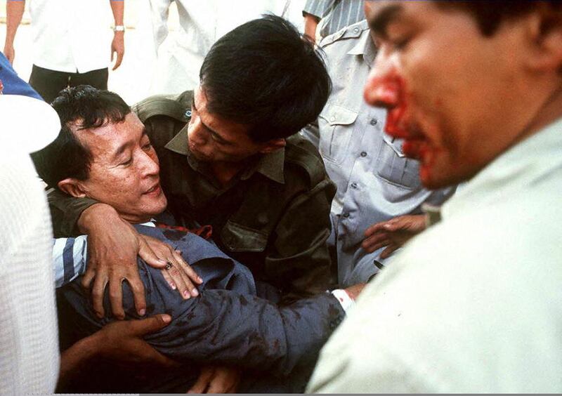 Sam Rainsy is carried away in state of shock after a grenade attack on a group of demonstrators outside the National Assembly building in Phnom Penh, March 30, 1997. Credit: AFP