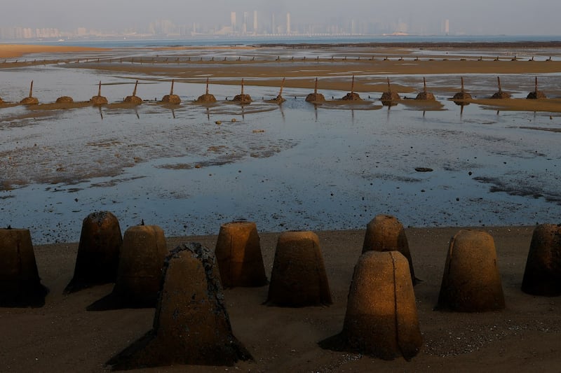 Anti-landing barricades remain on a beach in Kinmen December 20, 2023, that faces China's Xiamen. They serve as reminders of their armed conflict during the 1950s. (Ann Wang/Reuters)