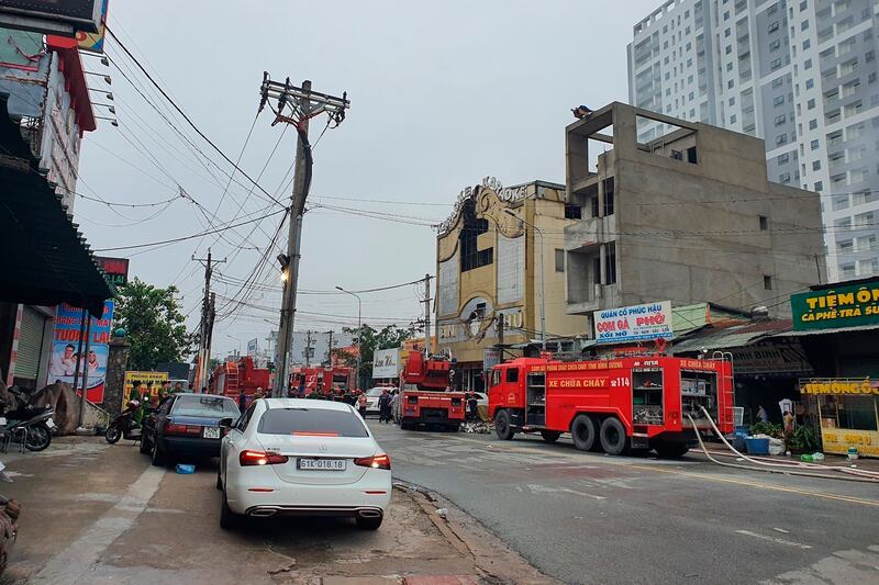 Fire department trucks line up outside a karaoke parlor following a fire in Thuan An city, Vietnam, Sept. 7, 2022. Credit: VNA via AP