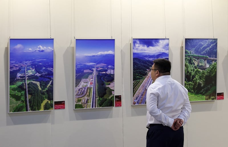 A man visits a photo exhibition on the Laos-China Railway at the Cultural Palace of Nationalities in Beijing on June 18, 2024. (Jia Tianyong/China News Service/VCG via Getty Images)