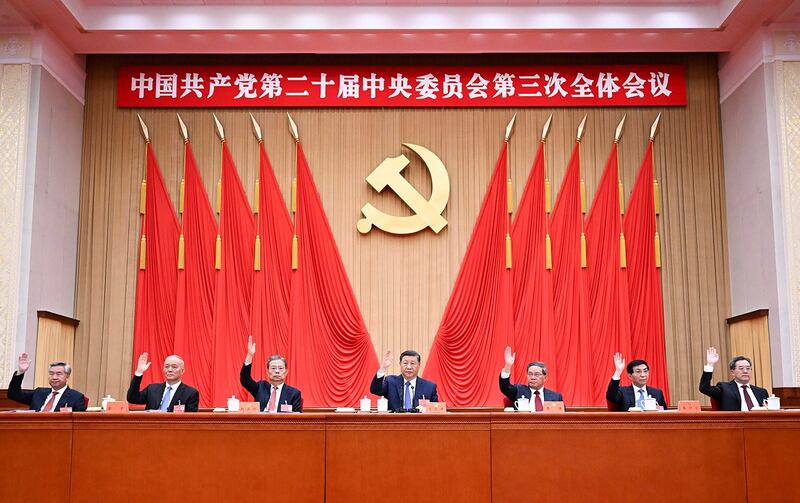 Chinese President Xi Jinping, center, and other members of the Politburo Standing Committee attend the third plenary session of the 20th Communist Party of China Central Committee held from July 15 to 18 in Beijing. (Xie Huanchi/Xinhua via AP)