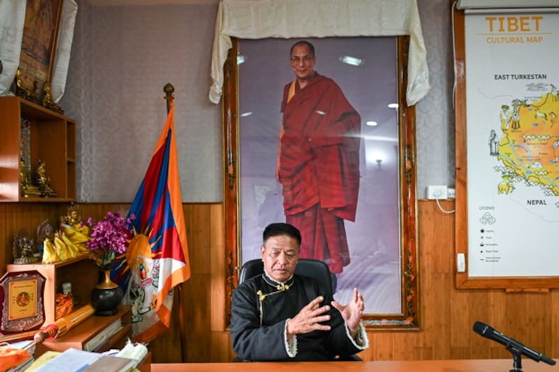 Penpa Tsering, the sikyong or leader of the Tibetan government-in-exile, speaks during an interview with AFP in his office in front of a portrait of the Tibetan Buddhist spiritual leader the Dalai Lama seen in the background, in Dharamsala, India, Feb. 19, 2024. (Sajjad Hussian/AFP)