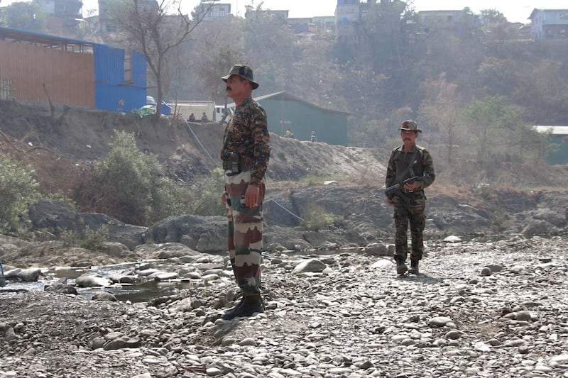 In this March 12, 2021 photo, Indian army soldiers patrol along the banks of the Tiau River, a natural border between India and Myanmar, close to the Zokhawthar border in India's northeastern state of Mizoram. Credit: Jacob Khawlhring/AFP