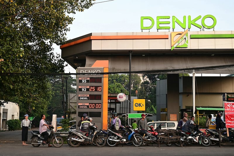 Motorists line up to fill their vehicles at a petrol station in Yangon on Dec. 6, 2023. (AFP)