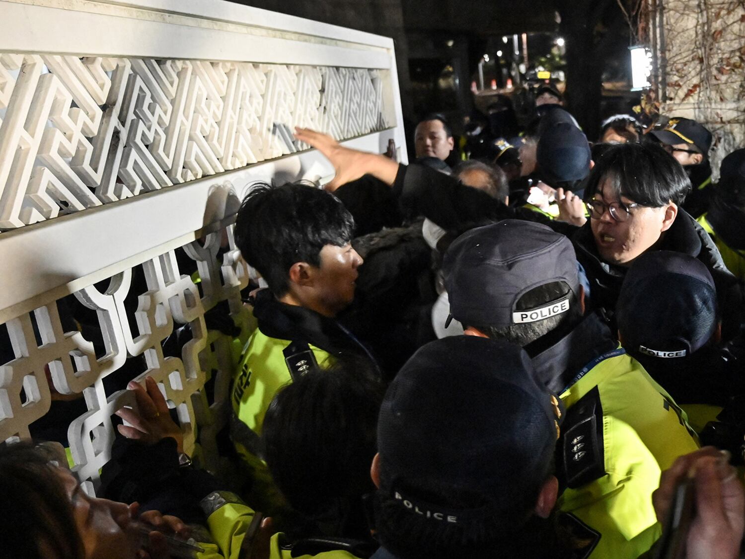 Police attempt to hold back people trying to enter the National Assembly in front of the main gate of the National Assembly in Seoul, on Dec. 3, 2024, after President Yoon Suk Yeol declared emergency martial law.