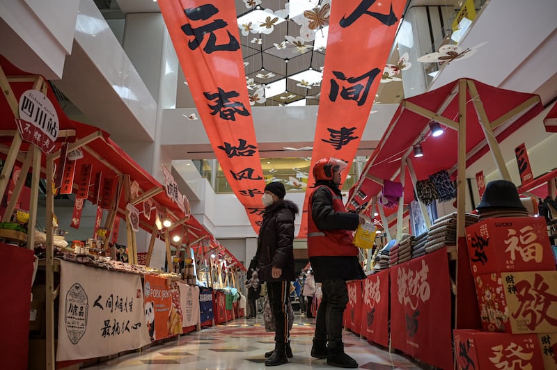 People visit a new year's fair inside a shopping center in Beijing, Jan. 17, 2025.