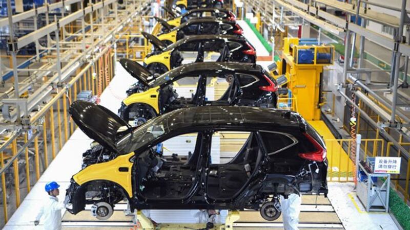 Employees work on an assembly line at Dongfeng Honda's third auto plant in Wuhan, central China's Hubei province, Nov. 27, 2019.