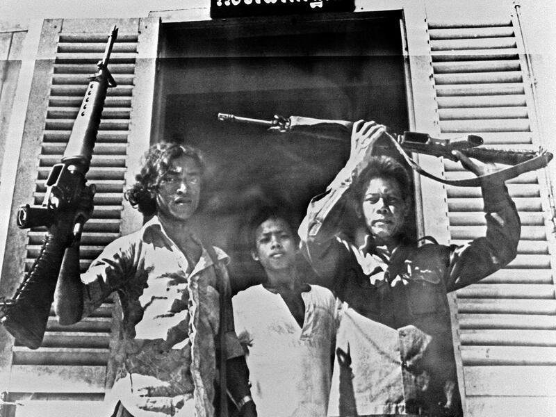 Khmer Rouge fighters brandish their rifles after seizing the garrison protecting Poipet village on the Thai-Cambodia border, April 19, 1975.