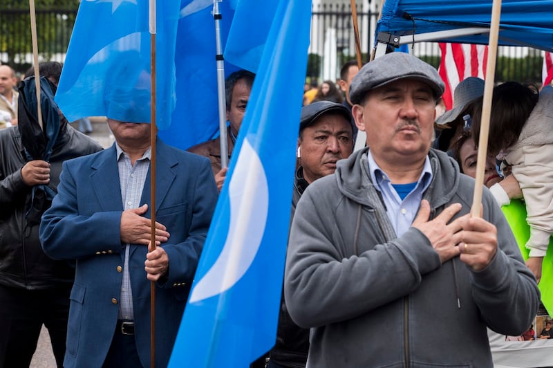 Members of the East Turkistan Awakening Movement sing the East Turkistan national anthem during a rally Oct. 1, 2022, outside the White House against the Chinese Communist Party. Credit: AP