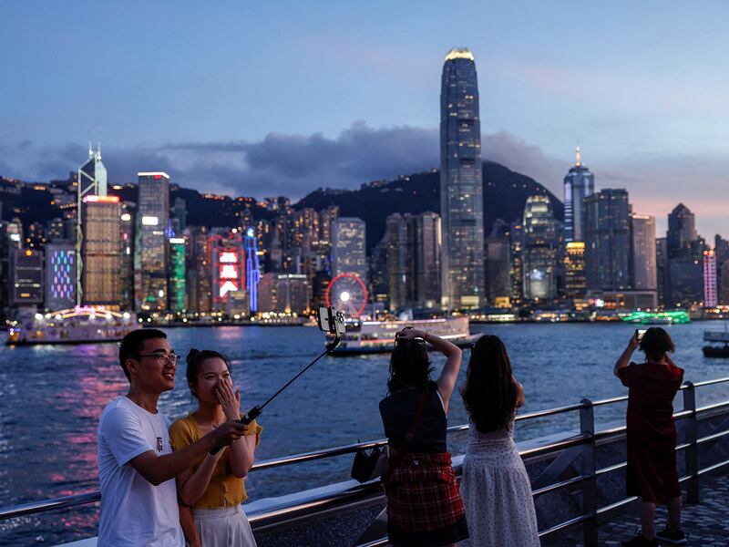 Tourists make photos of Hong Kong's financial district, in Tsim Sha Tsui, July 23, 2024.