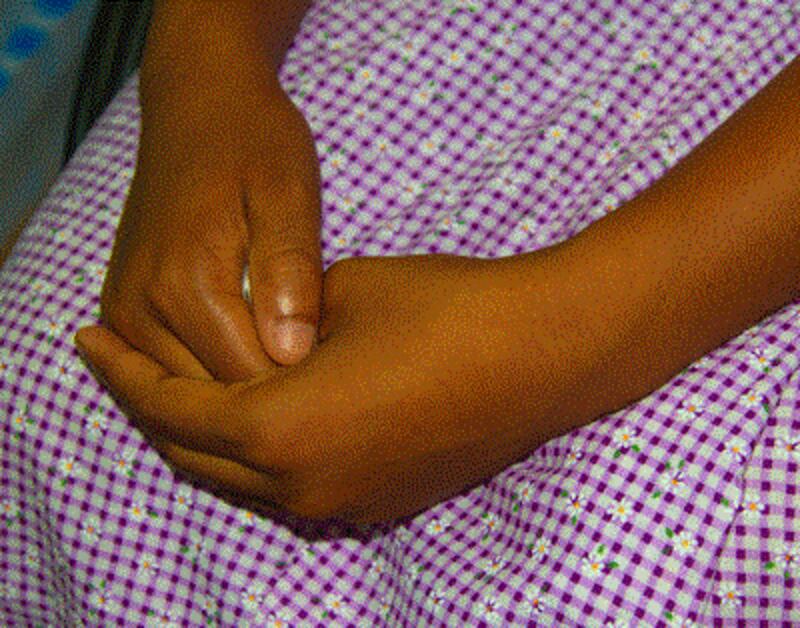 Aye Aye wrings her hands as she tells her story in the U.N. anti-trafficking agency's office in Rangoon, Oct. 23, 2012.