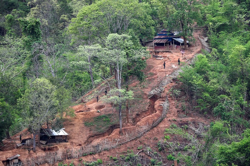 Ethnic minority Karen troops approach a Myanmar army outpost near the Thai border, which is seen from the Thai side on the Thanlwin, also known as Salween, riverbank in Mae Hong Son province, Thailand, April 28, 2021. Credit: Reuters