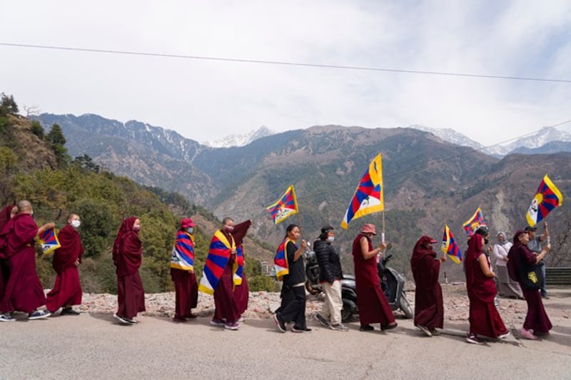 Exile Tibetans carry flags and shout slogans as they participate in a rally to commemorate the anniversary of the 1959 uprising in Tibet, in Dharamsala, India, March 10, 2024. (Ashwini Bhatia/AP)