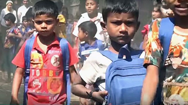 Rohingya children walk to a schoolhouse at the Thekkeh Byin displacement camp outside Sittwe in western Myanmar's Rakhine state, February 2020.