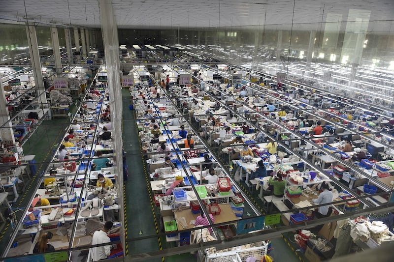 Garment workers make clothes at a factory in Phnom Penh, Cambodia on Dec. 17, 2021. (Wu Changwei/Xinhua via Getty Images)