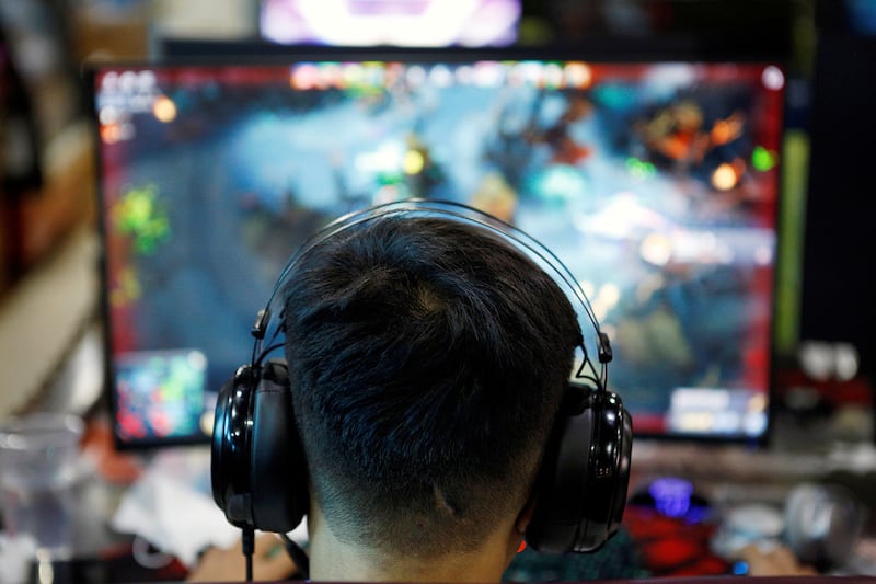 A man plays an online game at an internet cafe in Beijing, Aug. 31, 2021.