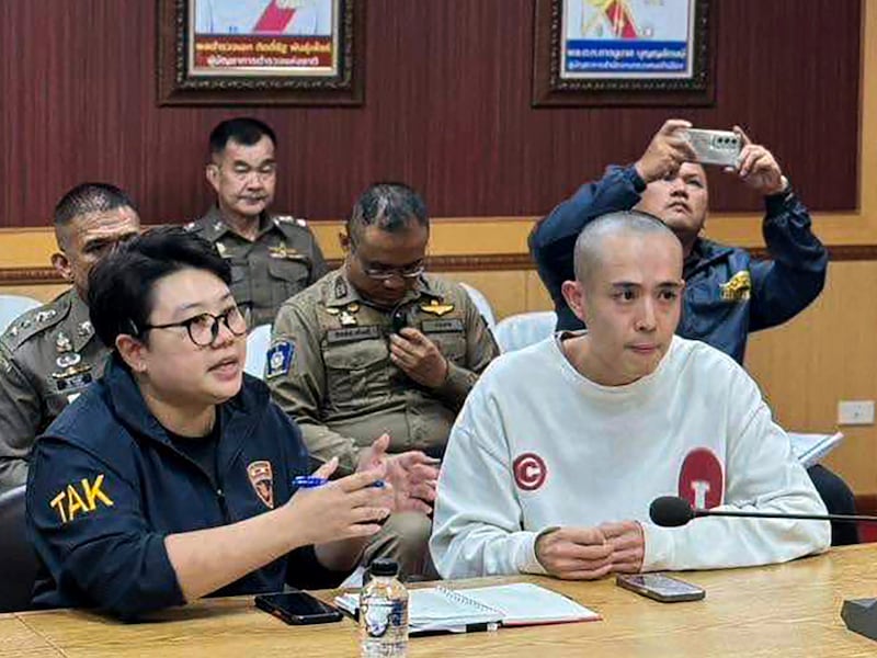 Chinese actor Wang Xing (right) talks with Thai police officers in Mae Sot district on the Thai-Myanmar border in Thailand's Tak province, Jan. 7, 2025.