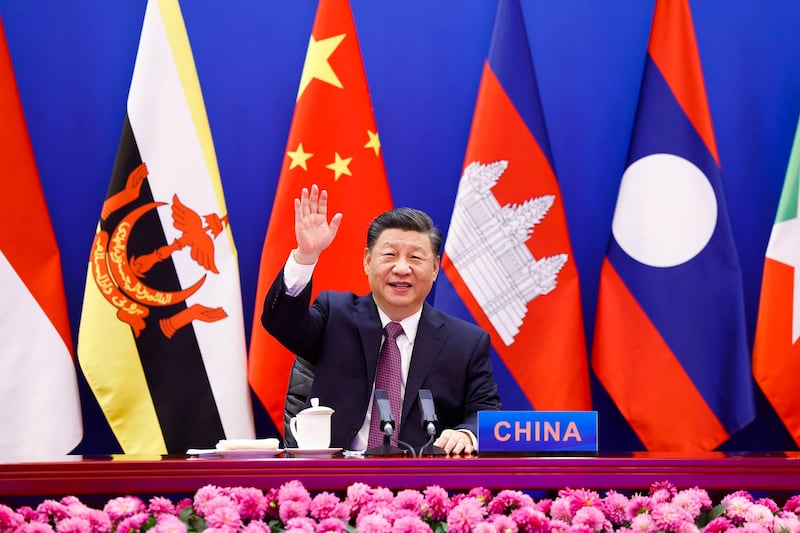 Chinese President Xi Jinping waves as he chairs the ASEAN-China Special Summit to commemorate the 30th Anniversary of ASEAN-China Dialogue Relations via video link from Beijing, China on Nov. 22, 2021. Credit: Xinhua via AP