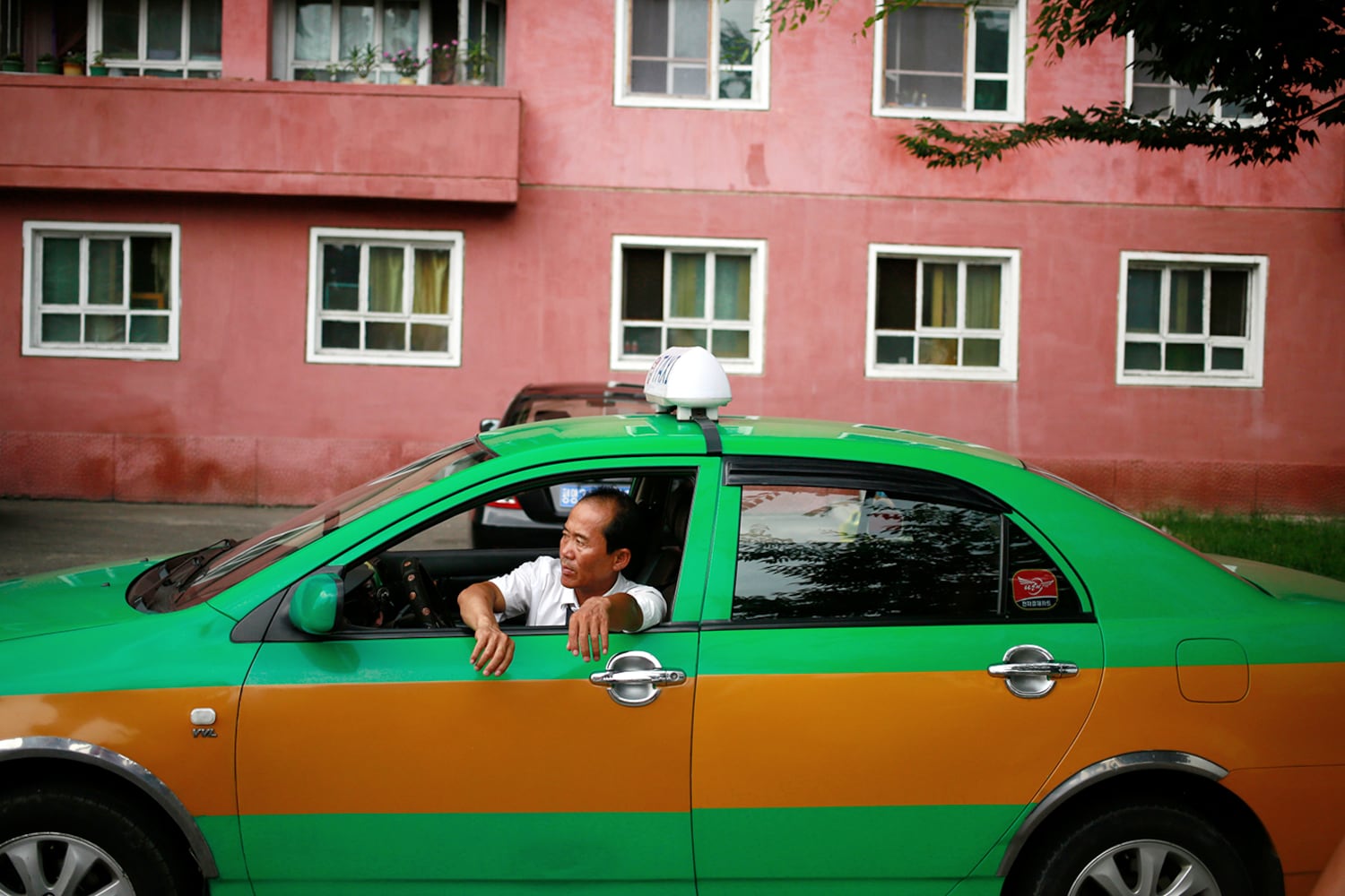 A taxi driver waits for customers in Pyongyang, North Korea,  July 26, 2018.