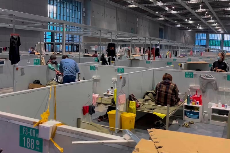 In this image taken from video provided by Beibei, who asked to be identified only by her given name, residents take a rest at Shanghai's National Exhibition and Convention Center, which converted to a quarantine facility set up for people who tested positive but have few or no symptoms, April 15, 2022. Credit: Beibei via AP