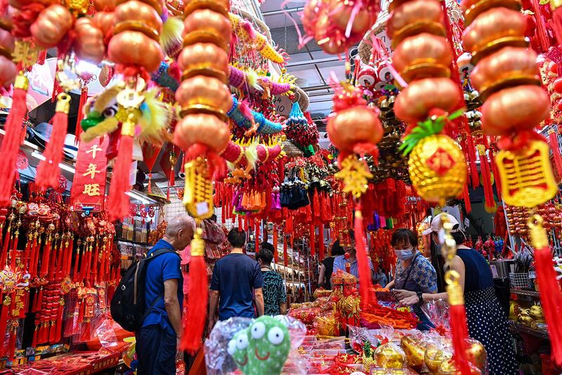 Decorative ornaments and greeting banners are displayed at a street stall ahead of Lunar New Year in Singapore's Chinatown on Jan. 26, 2024. (Roslan Rahman/AFP)