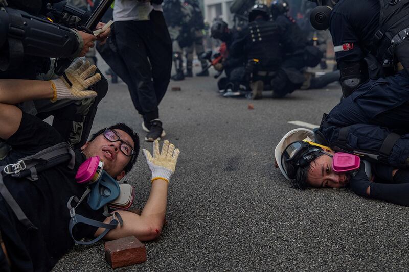 Anti-government protesters are detained during skirmishes with police in Hong Kong, Sept. 29, 2019. (Susana Vera/Reuters)